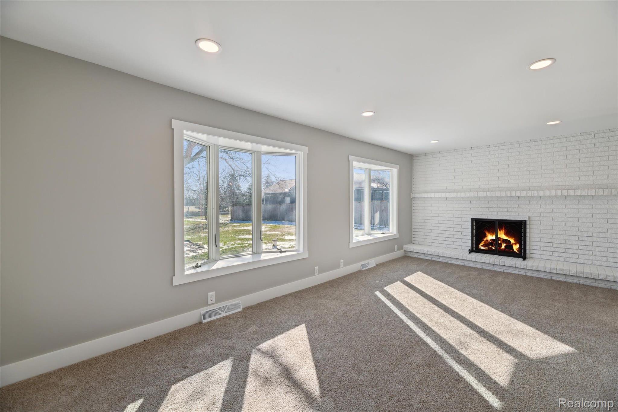 18350 Hickory Ridge Road Fenton, MI 48430 - Photo 5 of 30 Living room is bright and has a fireplace.