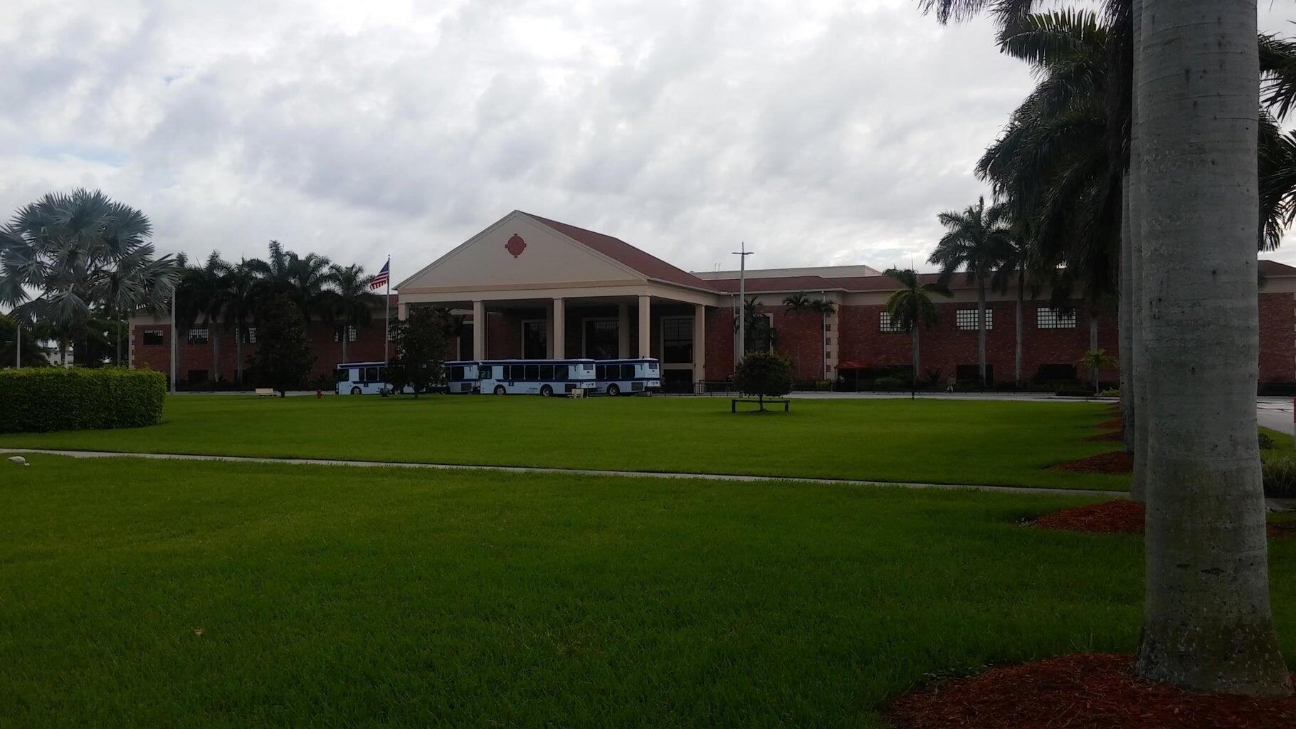 251 Fanshaw F Boca Raton, FL 33434 - Photo 13 of 14 a front view of a house with a yard and trees