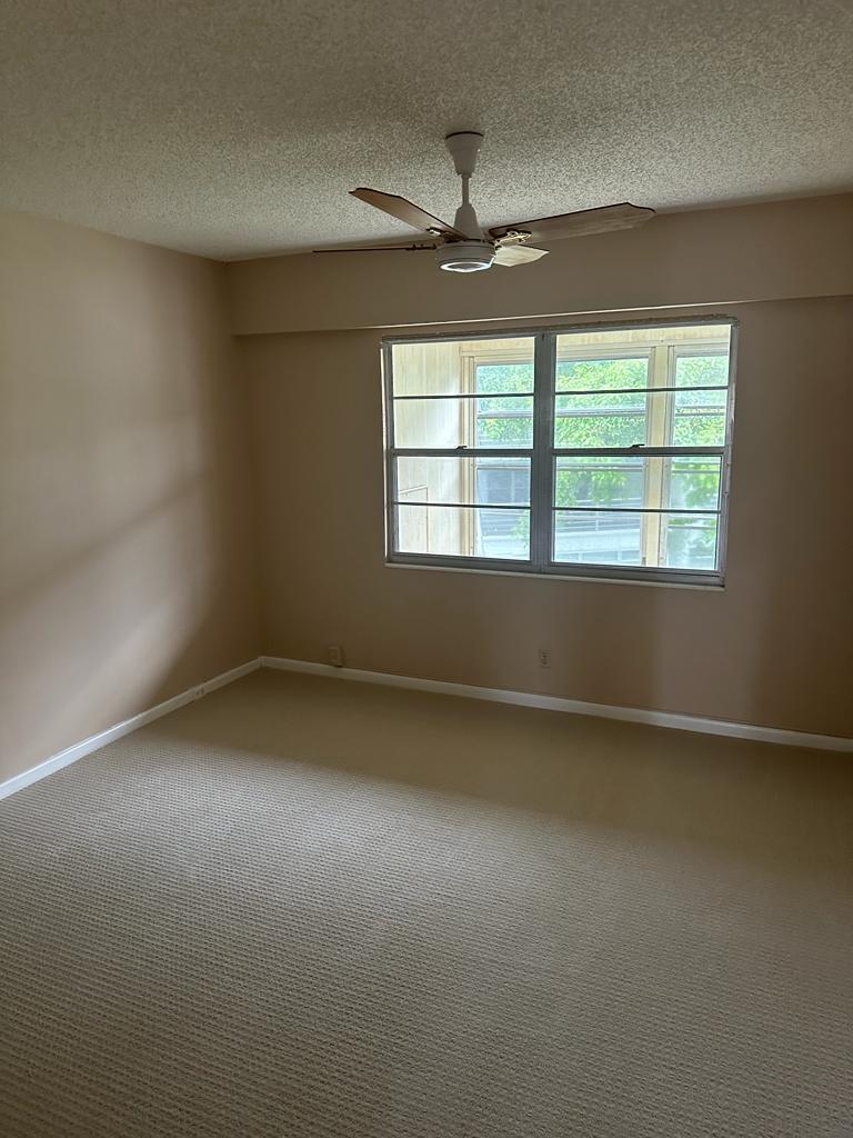 251 Fanshaw F Boca Raton, FL 33434 - Photo 5 of 14 an empty room with a window