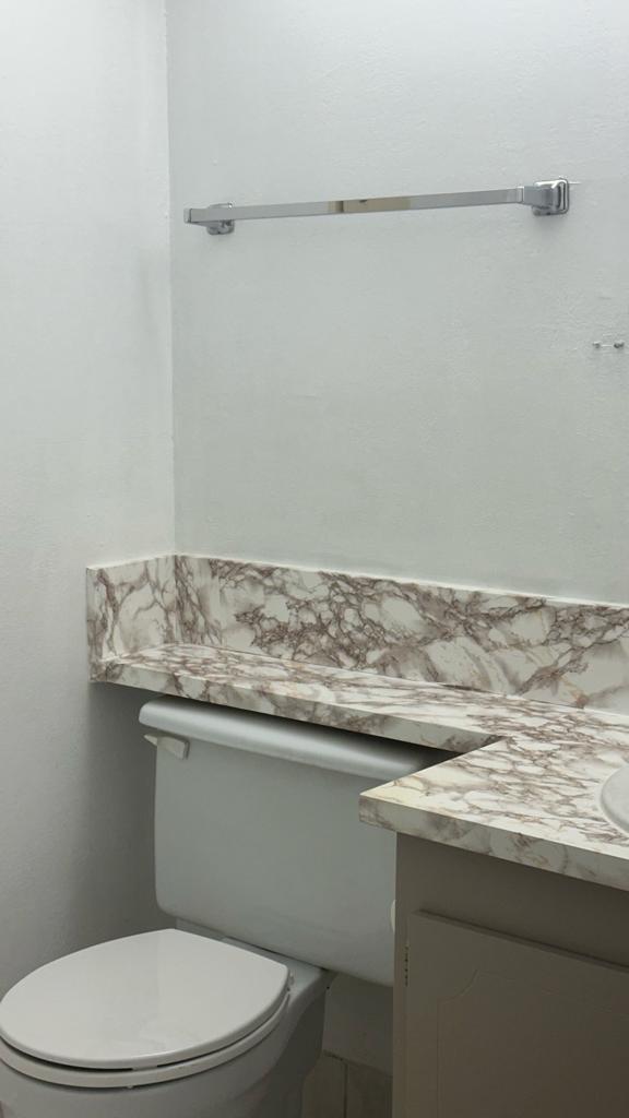 251 Fanshaw F Boca Raton, FL 33434 - Photo 9 of 14 a bathroom with a granite countertop toilet sink and mirror