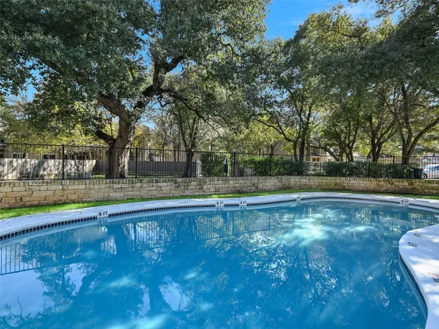 a view of pool with green space and yard