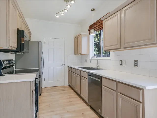 a kitchen with a sink stove and refrigerator
