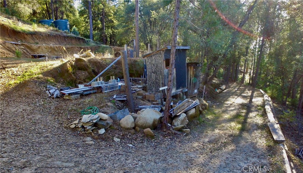 50963 Chu Ranch Road Oakhurst, CA 93644 - Photo 23 of 26 a backyard of a house with barbeque oven table and chairs