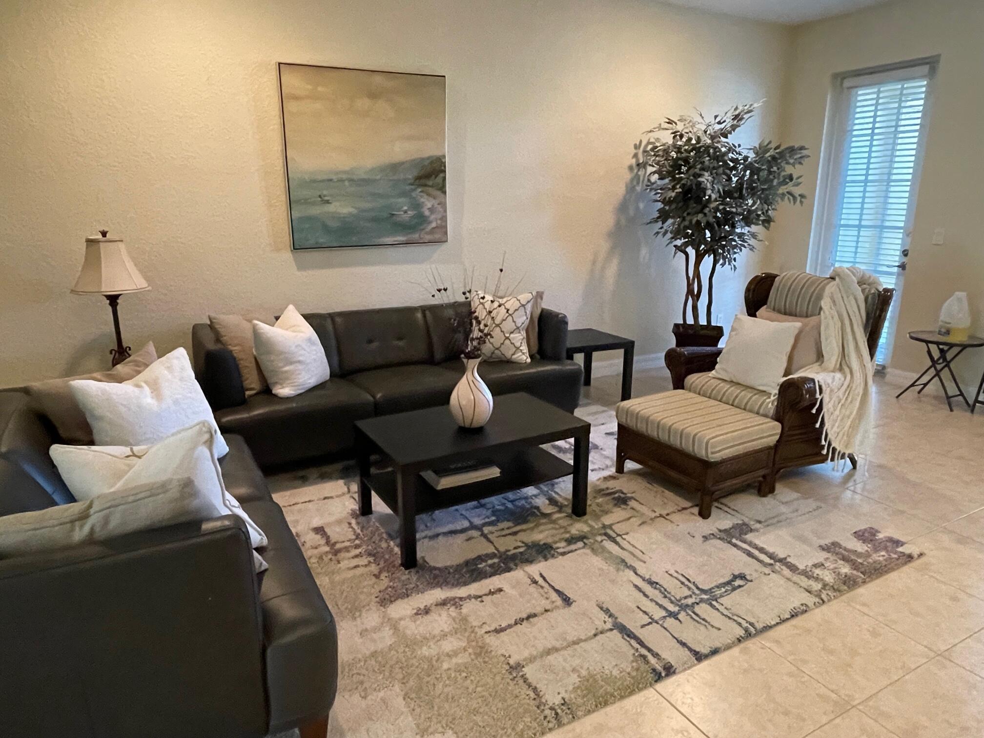 107 Mulligan Place Jupiter, FL 33458 - Photo 11 of 43 a living room with furniture and a potted plant