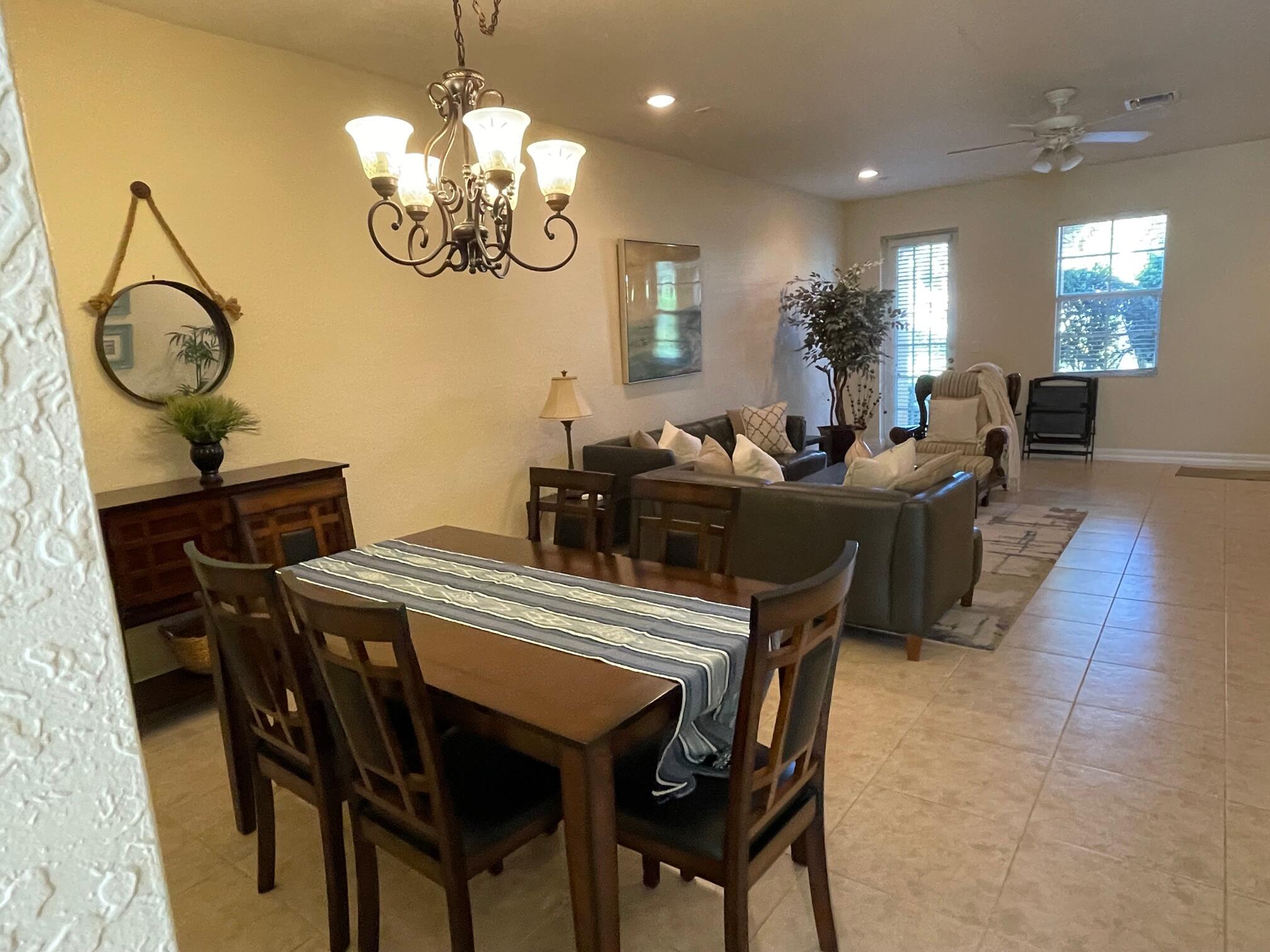 107 Mulligan Place Jupiter, FL 33458 - Photo 15 of 43 a view of a dining room with furniture and chandelier