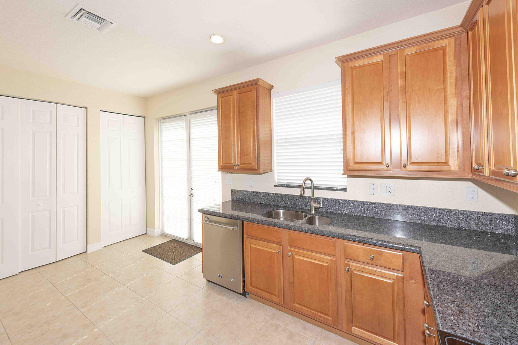 107 Mulligan Place Jupiter, FL 33458 - Photo 17 of 43 a kitchen with stainless steel appliances granite countertop a sink and a granite counter tops with a large window