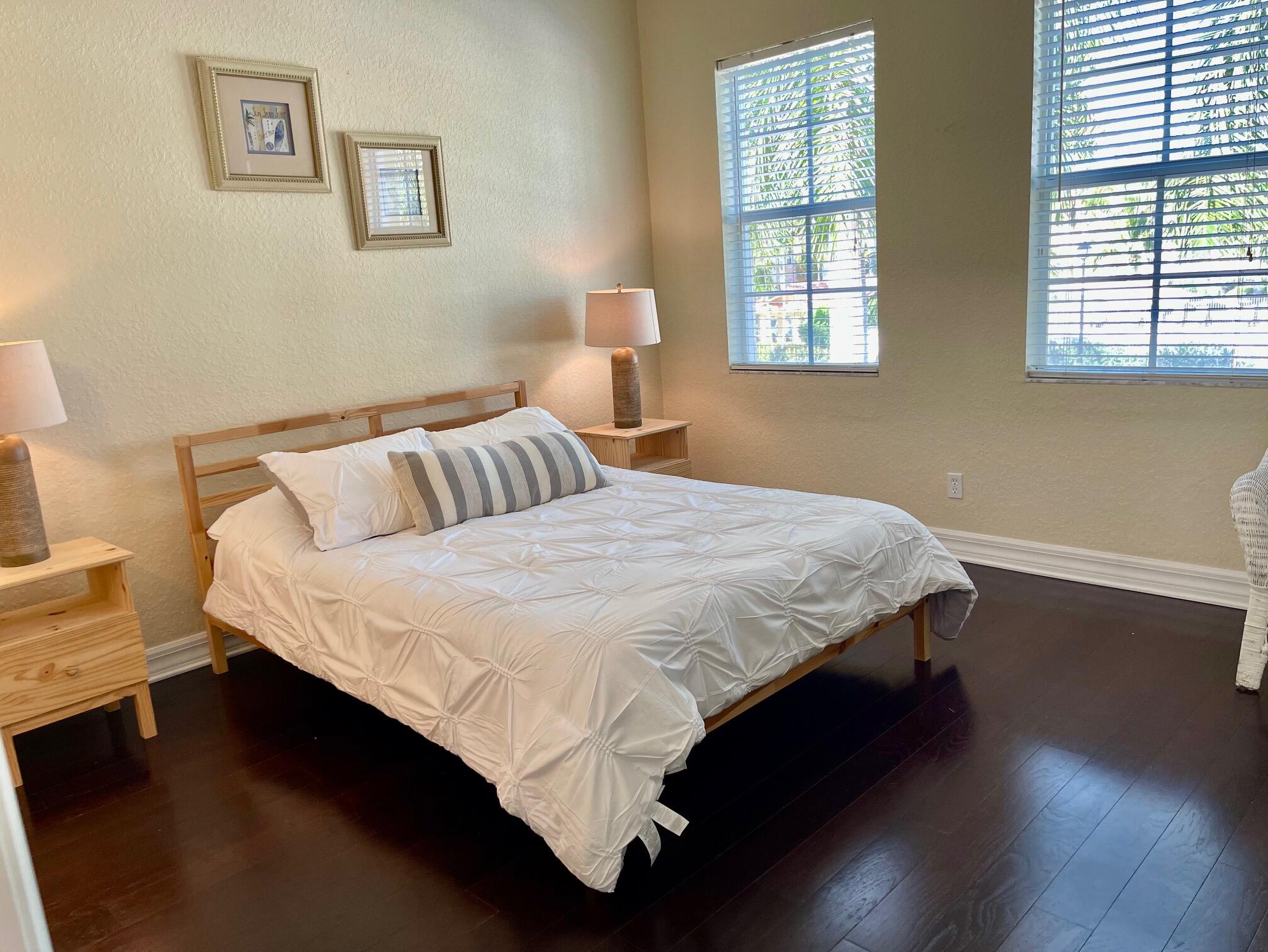 107 Mulligan Place Jupiter, FL 33458 - Photo 20 of 43 a bedroom with a bed and wooden floor