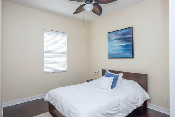 a bedroom with a bed and wooden floor