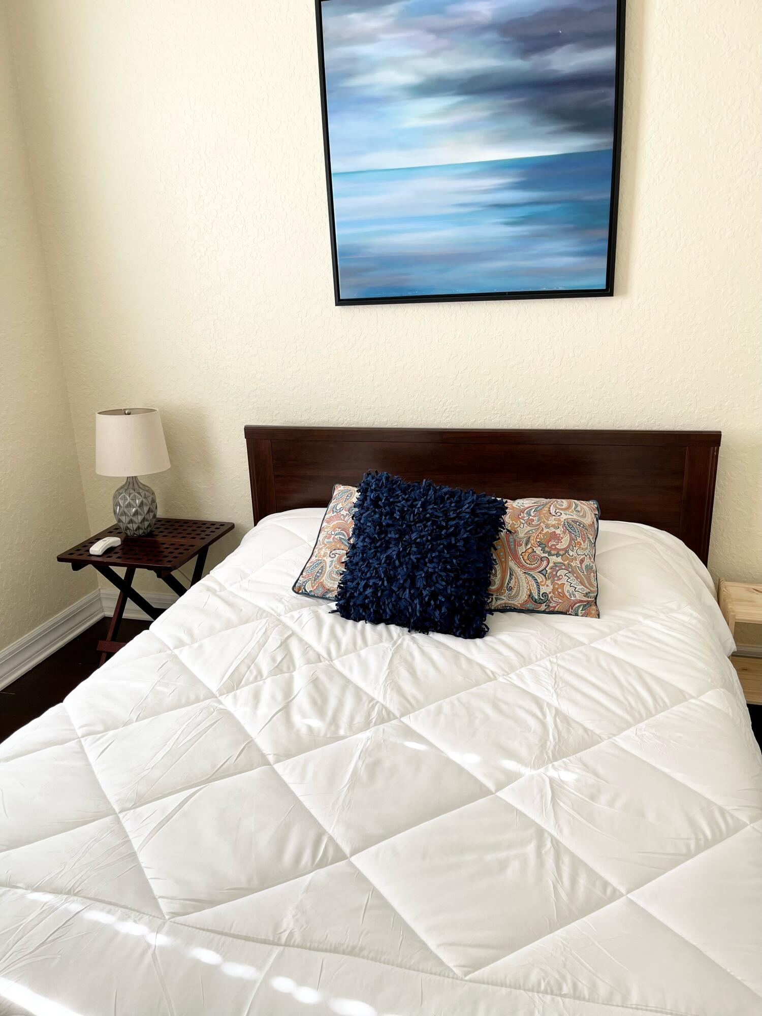 107 Mulligan Place Jupiter, FL 33458 - Photo 31 of 43 a bedroom with a bed and a night stand