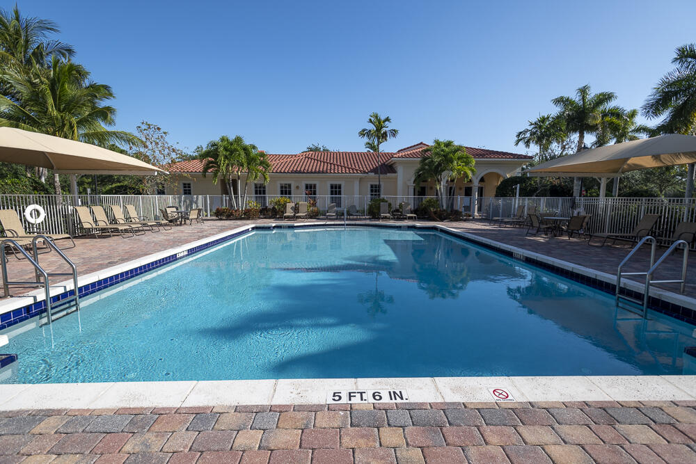 107 Mulligan Place Jupiter, FL 33458 - Photo 33 of 43 a front view of house with yard and outdoor seating