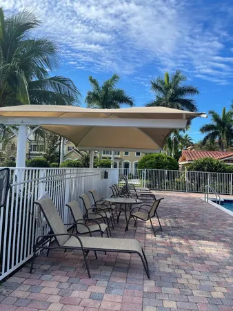 a view of a patio with furniture and a yard