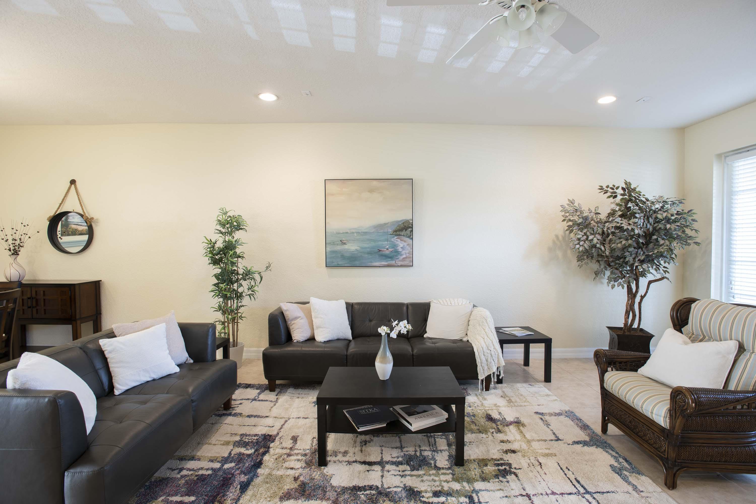 107 Mulligan Place Jupiter, FL 33458 - Photo 8 of 43 a living room with furniture and a potted plant