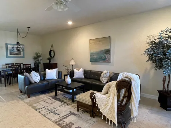 a living room with furniture and a mirror