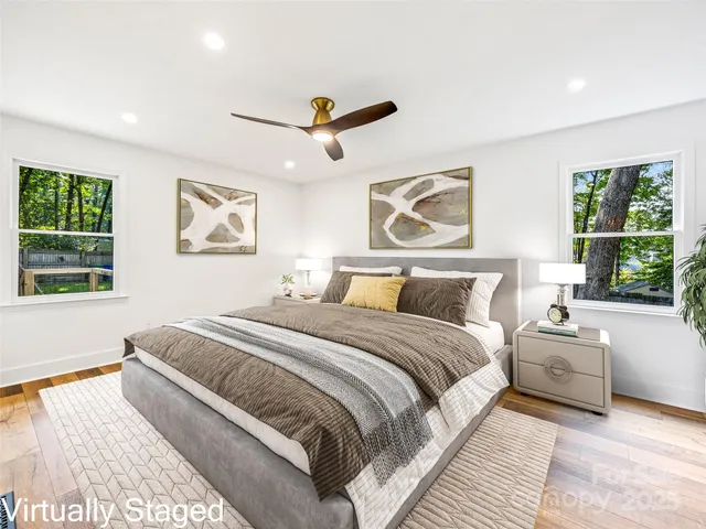 a bedroom with bed and a large window