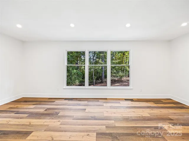 a view of a room with an empty space and a window