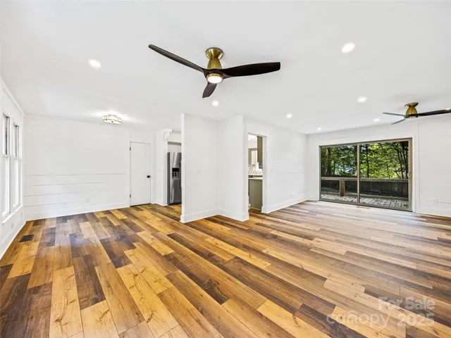 a view of a bedroom with a bed and a window