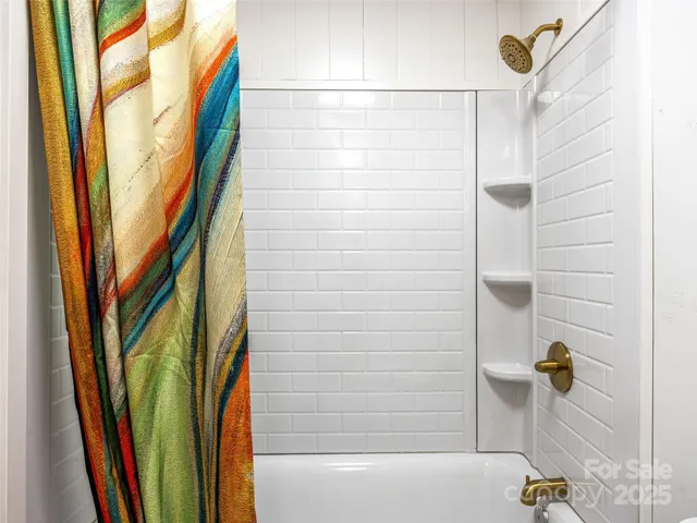 a bathroom with a shower and a bathtub