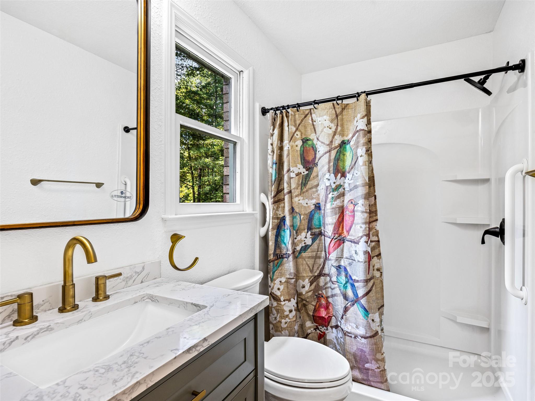 10 Westfield Road Fletcher, NC 28732 - Photo 33 of 45 a bathroom with a granite countertop sink toilet and shower