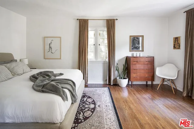 a bedroom with a bed and a chair