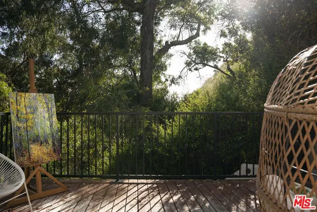 a view of balcony with wooden floor and fence