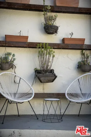 a view of a room with furniture and wooden floor