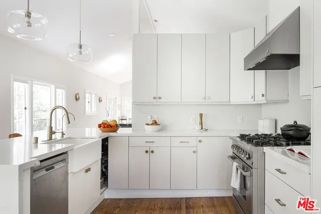 a kitchen with a sink stove and cabinets