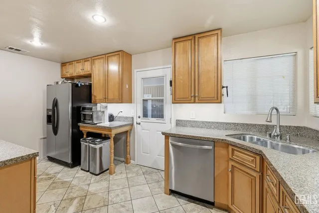 a kitchen with a sink appliances and cabinets