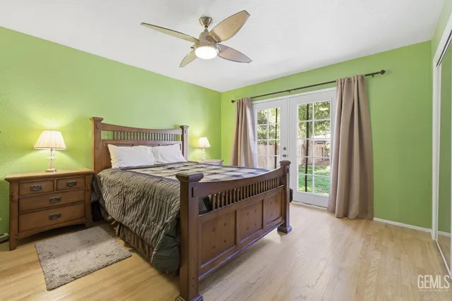 a bed sitting in a spacious bedroom next to a window