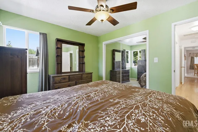 a bedroom with a bed and a large mirror