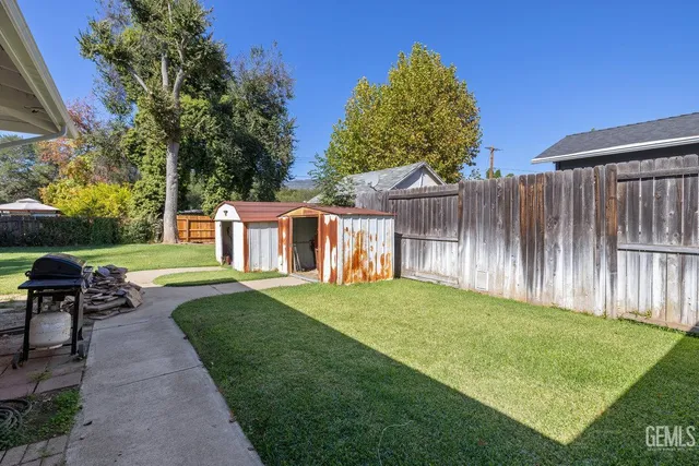 a view of a backyard with table and chairs and a slide