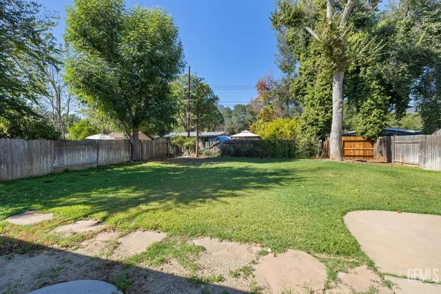 a view of a backyard with a garden and trees