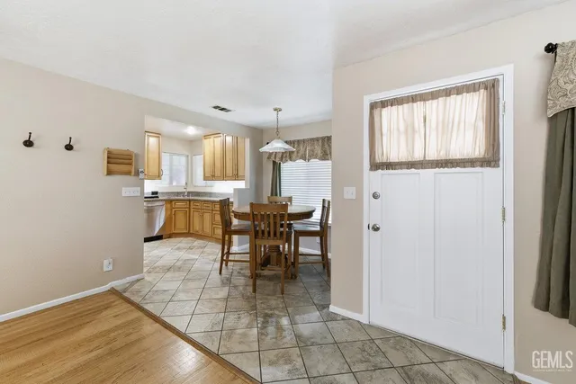 a view of a dining room with furniture and a window