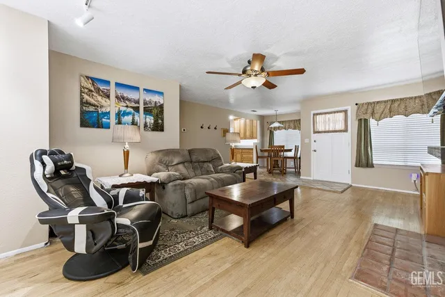 a living room with furniture a rug and a chandelier