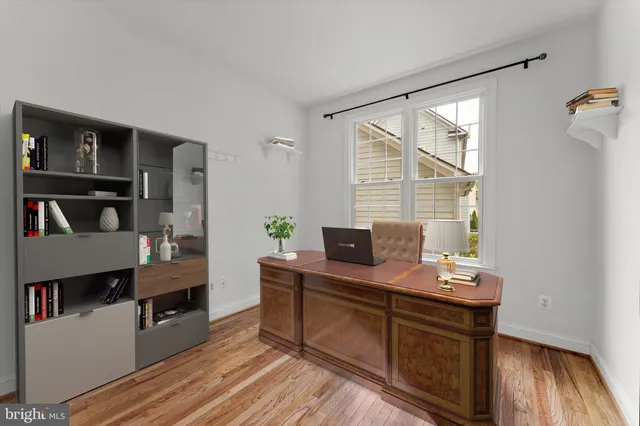 a view of a workspace with furniture and wooden floor