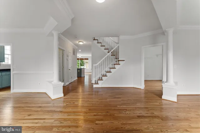 a view of entryway and hall with wooden floor