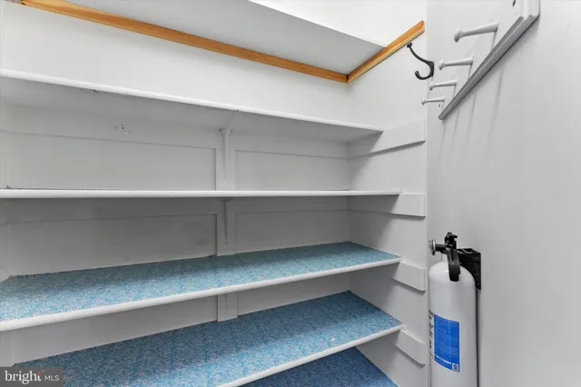 a view of empty room with wooden floor and fireplace