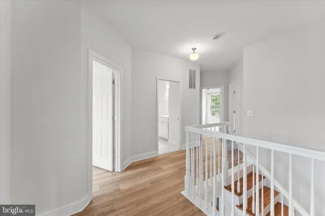 a view of a livingroom with a ceiling fan window and wooden floor