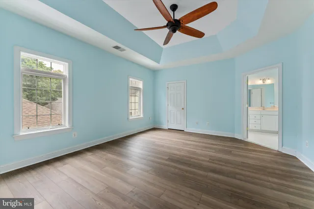 a view of empty room with wooden floor