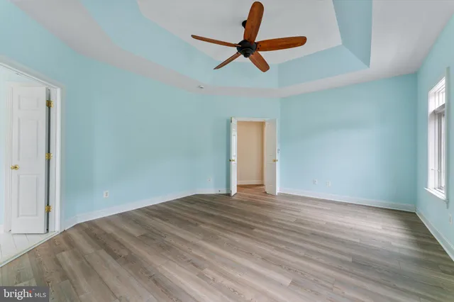 a bathroom with a bathtub a mirror a double vanity sinks and vanity