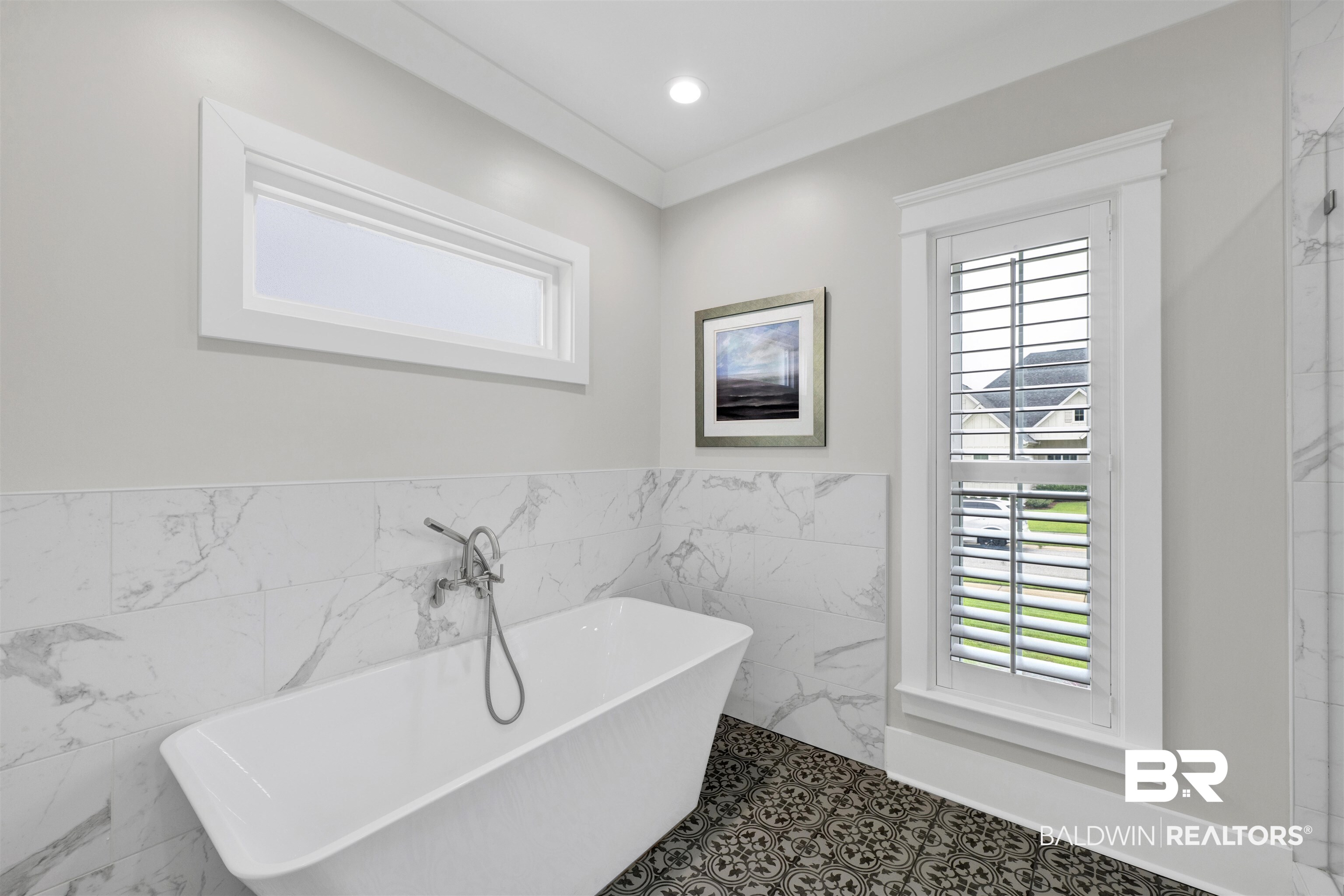 21702 Pillars Street Fairhope, AL 36532 - Photo 24 of 54 Freestanding soaking tub with floor-mounted faucet, surrounded by marble-look tile walls