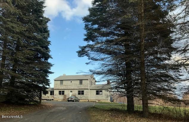a view of a big house with a trees