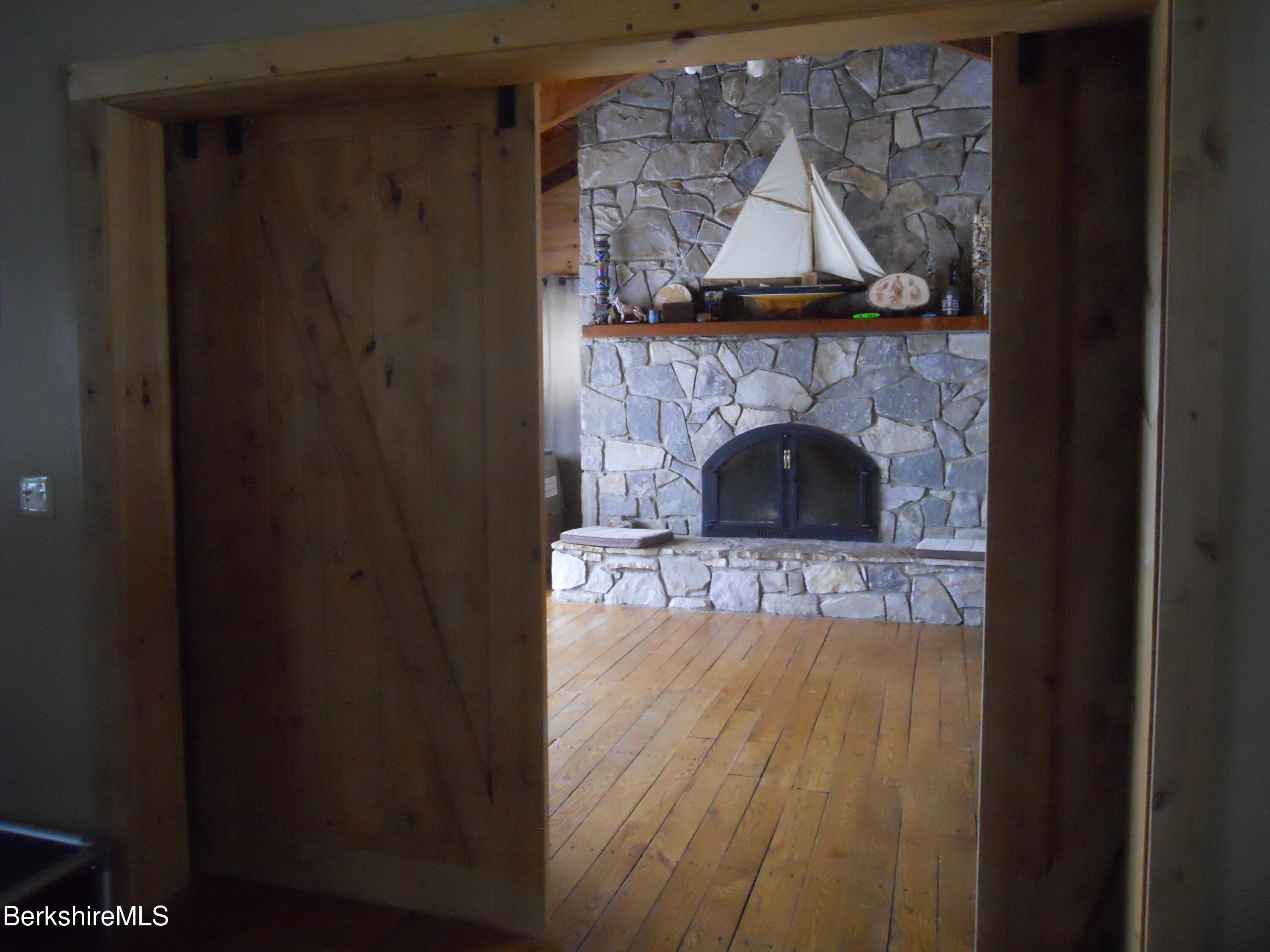 140 Arthur Pease Road Middlefield, MA 01011 - Photo 18 of 43 a living room with a fireplace