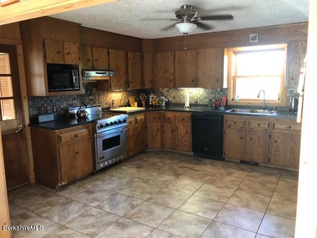 140 Arthur Pease Road Middlefield, MA 01011 - Photo 21 of 43 a kitchen with stainless steel appliances granite countertop a stove sink and cabinets