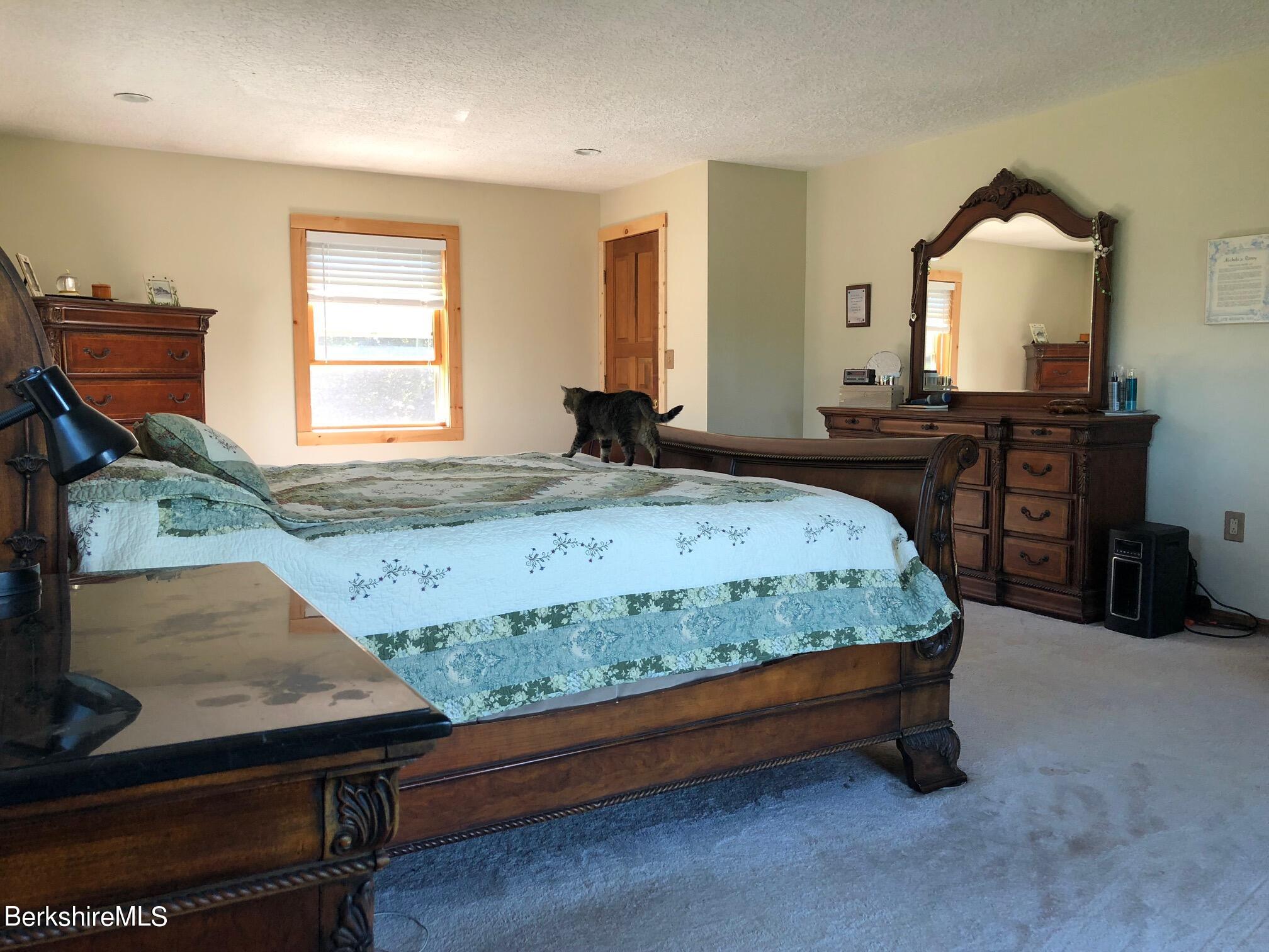140 Arthur Pease Road Middlefield, MA 01011 - Photo 27 of 43 a bedroom with a bed and a dresser