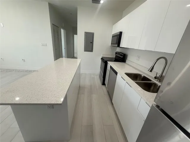 a view of a kitchen from a hallway