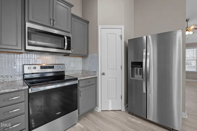 a bathroom with a double vanity sink toilet mirror and bathtub