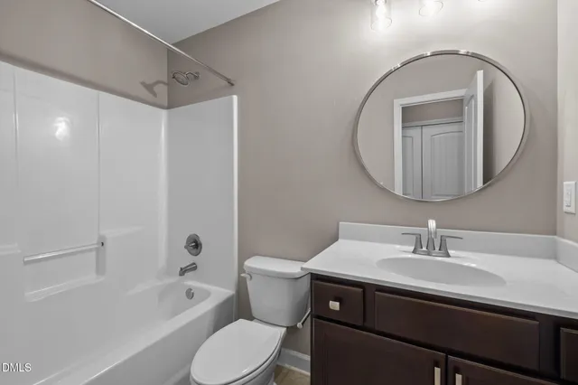 a view of a house with a yard and large trees