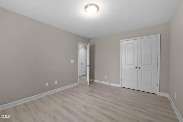 a view of a dry yard with trees