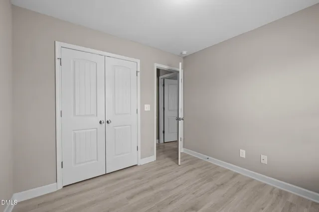 a balcony with wooden floor and fence