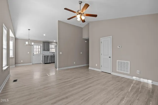 a view of wooden floor and windows in a room